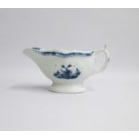 A Worcester Blue and White Sauce boat of pleated and moulded form, painted with two Chinese