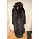 A ranch mink long line fur coat, button through with collar and waist belt, button details to cuffs,