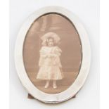 A George V silver oval photograph frame, wooden reverse, size approx 15.5 x 11.5cm  Birmingham 1915,