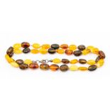 An amber necklace, comprising multi coloured pebble shaped beads, to include, clarified orange,