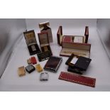 A collection of boxed cigarette lighters, including Dunhill, card boxes, Cartier gold plated pen and