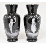 A pair of early 20th Century Mary Gregory glass vases with Victorian boy and girl design, 30cms high