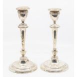 A pair of Edwardian silver candlesticks on turned stepped baseds with tapering columns Birmingham