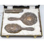 Early 20th Century silver dressing table set, with repousse scrolled foliate decoration, to