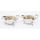 A pair of silver sauce boats, scrolled acanthus leaf handle on three hoofed feet, Sheffield 1889,