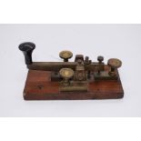 A 1930's Morse code machine, brass and mahogany
