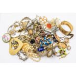 A collection of costume jewellery to including gilt metal chains, bangles, brooches along with white