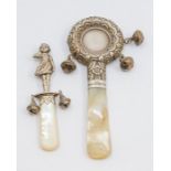 A Victoria silver mounted mother-of-pearl baby's rattle and teether, circular chased and repousse