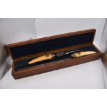Cased 19th Century meat carving set with monogrammed ivory handle, in a mahogany case, different