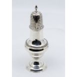 A George III silver sugar caster, beaded rims with engraved cross decoration to sifter and acorn