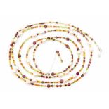 A long line bead necklace comprising various semi precious faceted beads including cultured pearl,