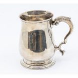 A George III silver plain baluster mug, C-scroll handle with acanthus thumbpiece, raised foot, by