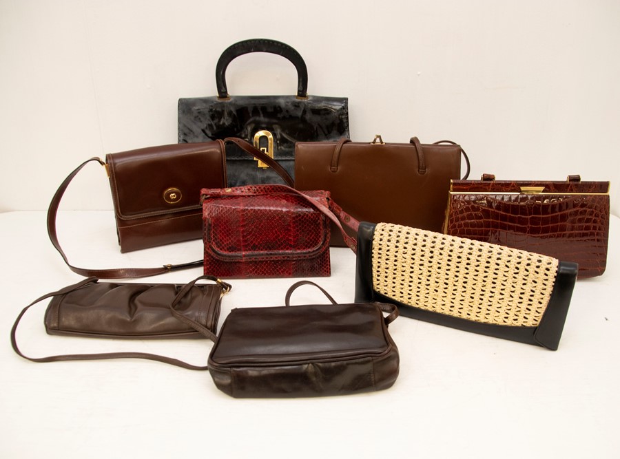 A collection of handbags, to include a small red snake skin effect leather structured bag, along