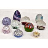 A collection of glass paperweights plus a plated tray