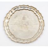 An Indian silver shaped circular presentation card tray, beaded rim, the centre engraved: