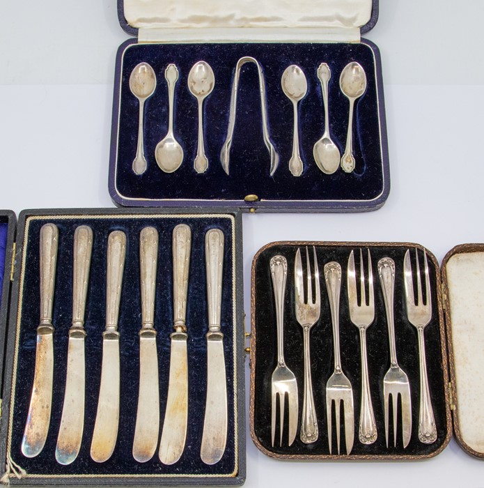 Cased silver spoons, butter knives and dessert forks