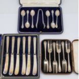 Cased silver spoons, butter knives and dessert forks