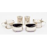 A George VI five piece Neo-Classical style silver condiment set to include: pair of salts, pair of