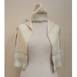 A children's ribbed knitted 1920/30's long cardigan, edged in blue, the collar also has a blue