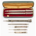 An Edwardian silver combination pen and pencil with seal top terminal, profusely engraved by