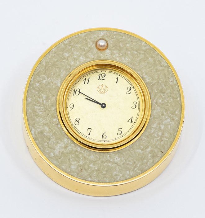 A Mikimoto International travel clock, comprising a gold tone round dial, with number markers,