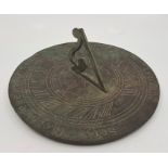 A sundial, with eight point compass rose, diameter 20.2cm.