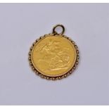 Gold full sovereign mounted with associated yellow metal chain
