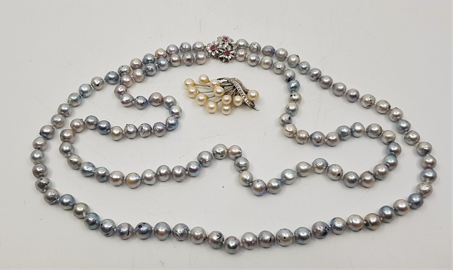 A double row cultured pearl necklace, with 14ct. white gold triple "daisy" clasp, set three round