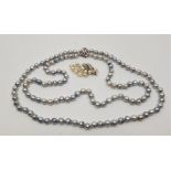 A double row cultured pearl necklace, with 14ct. white gold triple "daisy" clasp, set three round