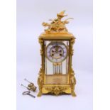 A large French gilt ormolu mantle clock, the enamel dial marked Paris, pendulum with swinging cherub