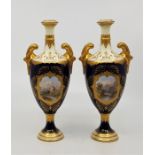 A pair of Coalport porcelain ovoid two handled vases, with leafage scroll gilt handles with cream