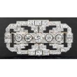 An Art Deco diamond set platinum clip/ brooch, the rectangular open form, set to the centre with a