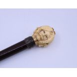 A finely carved Ivory walking cane, silver collar and original ferule