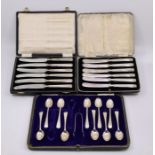 Two early 20th cent cased sets of silver butter knives and a part silver spoon set