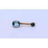 A Peridot bar brooch  and blue topaz stick pin