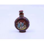 A Chinese yixing clay snuff bottle depicting scenes of lohan