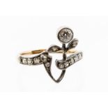 An Edwardian diamond and 15ct gold ring, comprising a floral open work detail, the flower with a