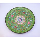 A large Chinese green ground Qing dynasty enamel charger with scrolling lotus flower