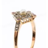 An Edwardian diamond, ruby and pearl rose gold ring, comprising a diamond shaped open work detail