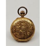 An 18ct. gold ladies' half hunter pocket watch, crown wind, having white enamel Roman numeral