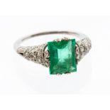 An Art Deco and diamond platinum ring comprising a rectangular cut emerald, approx 7 x 9mm, weight a
