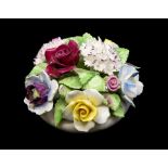 A Royal Doulton china table decoration modelled as a flowers pot with bouquet of flowers in relief,