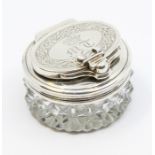 A George III cut glass circular box and silver hinged cover and collar, the cover engraved with an