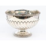 A late Victorian silver rose bowl, gadroon and rocaille border above wyvern fluting to lower section