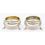 A pair of Georgian style silver salts, plain circular on three hoof feet, by Elkington & Co.,