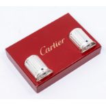 A pair of Cartier demi-lune silver plate salt and peppers, applied with sapphire cabochon central