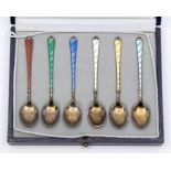A cased set of six Danish silver gilt enamel demitasse spoons, comprising turquoise, white, red,