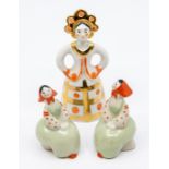 A 20th Century Russian ceramic model of woman in traditional dress, stamped on base and a pair of