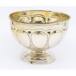 An Art Nouveau silver circular rose bowl, the body repousse with a band of egg shaped decoration