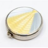 An Art Deco silver and enamel compact, the cover with sunbeam within blue radial design, mirror to